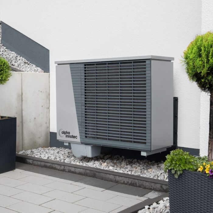 trees and air conditioner by building wall