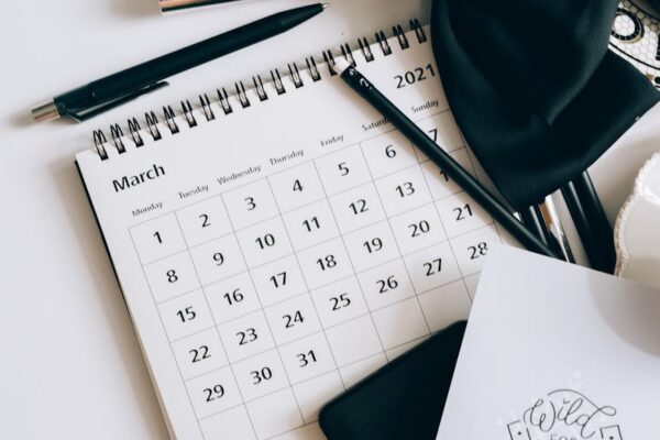 calendar coffee and chocolates on a white table