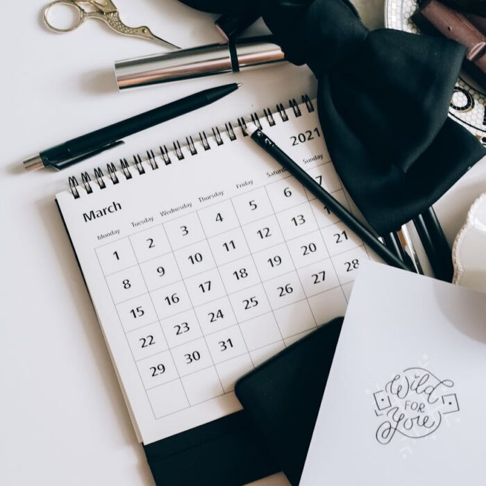 calendar coffee and chocolates on a white table