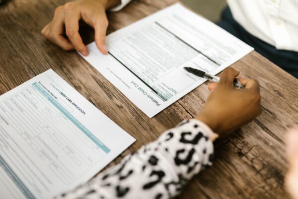person writing on white paper